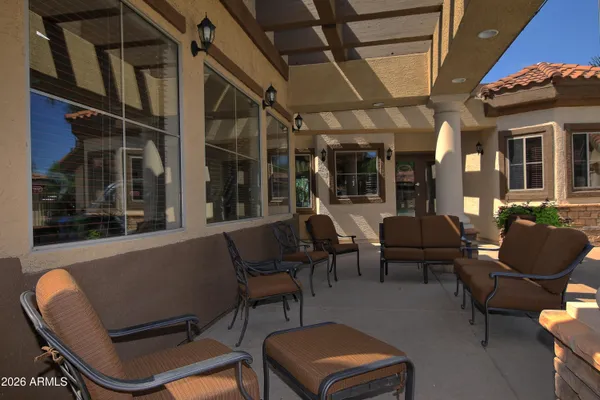 a dining room with furniture a rug and a painting
