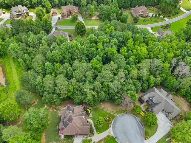 an aerial view of a house with garden space and street view