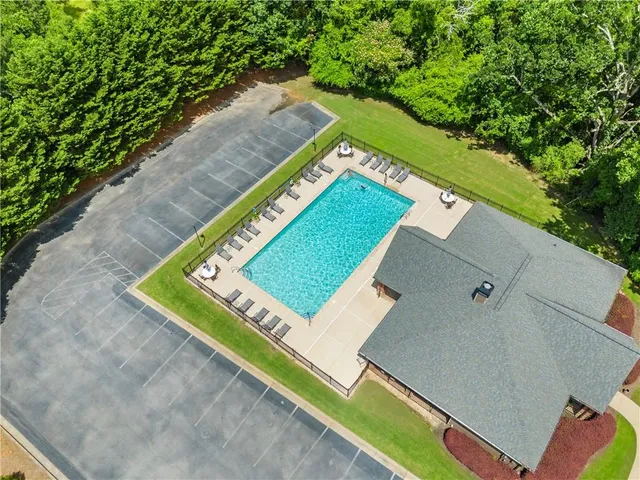 a view of a tennis court with a bench in the background