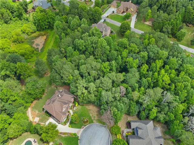 an aerial view of a house with yard swimming pool and outdoor seating