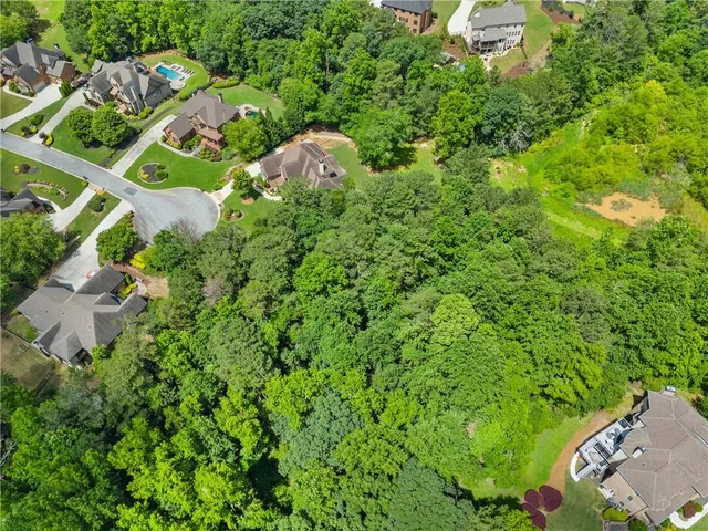 an aerial view of a house with lots of trees