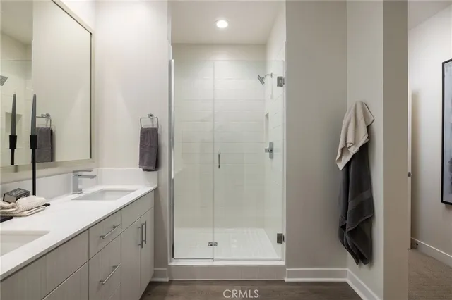 a bathroom with a shower sink and mirror