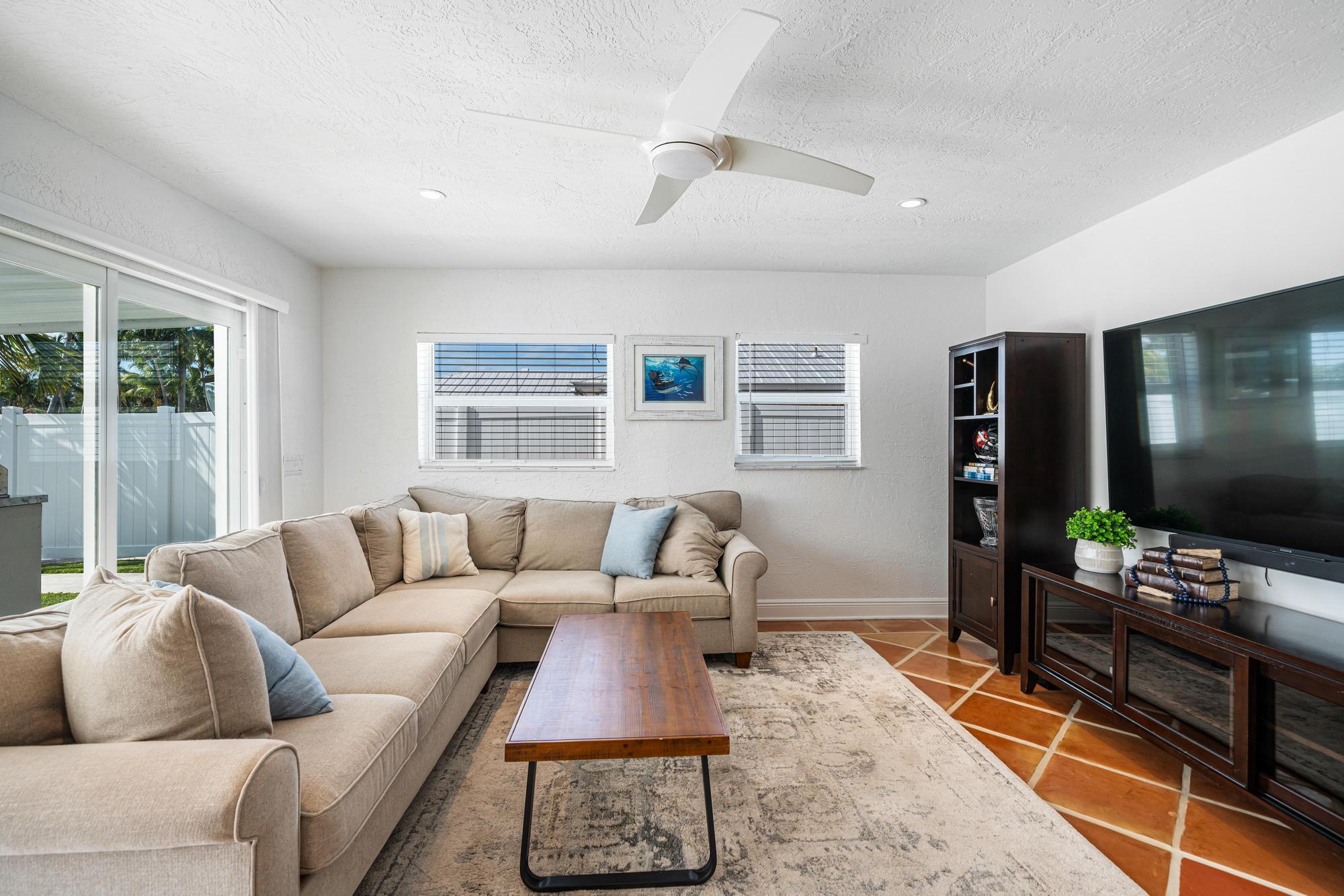 932 Marlin Circle Jupiter, FL 33458 - Photo 17 of 56 a living room with furniture and a flat screen tv