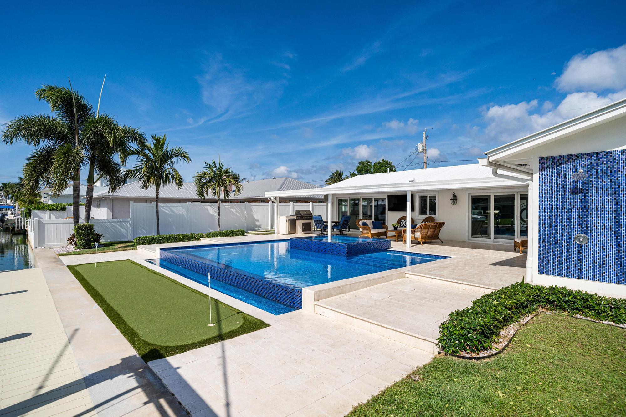 932 Marlin Circle Jupiter, FL 33458 - Photo 40 of 56 a view of an house with swimming pool and sitting area
