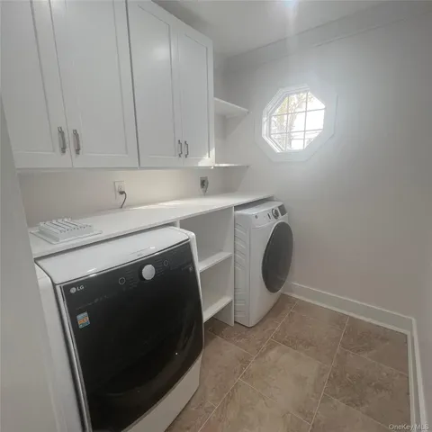 a utility room with sink dryer and washer