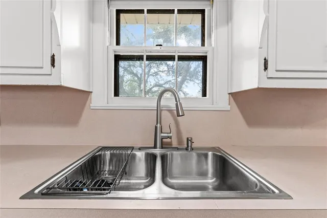 a kitchen with white cabinets and white appliances