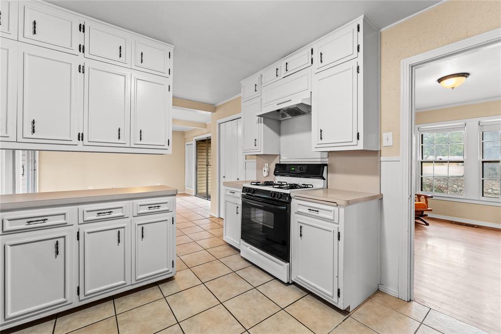 3808 North 27th Street Waco, TX 76708 - Photo 29 of 39 a kitchen with white cabinets and white appliances