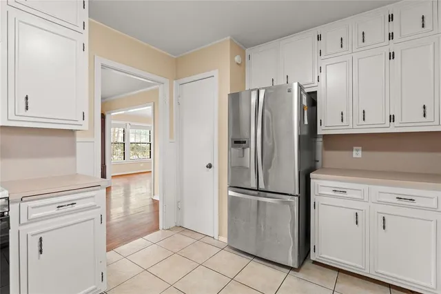 a kitchen with a sink a refrigerator and cabinets