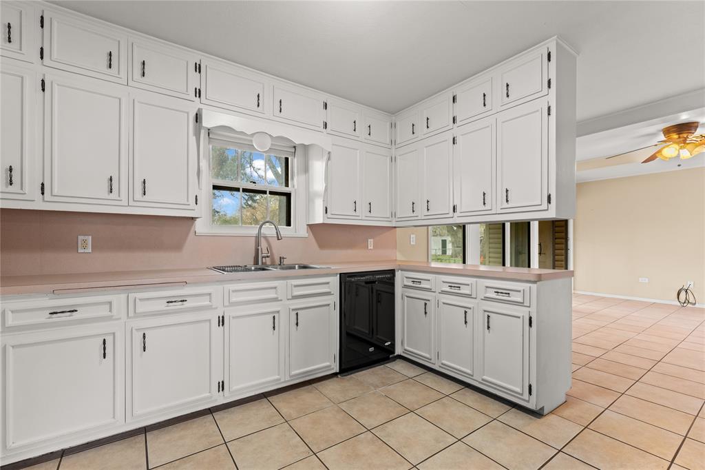 3808 North 27th Street Waco, TX 76708 - Photo 4 of 39 a kitchen with stainless steel appliances granite countertop white cabinets sink and dishwasher