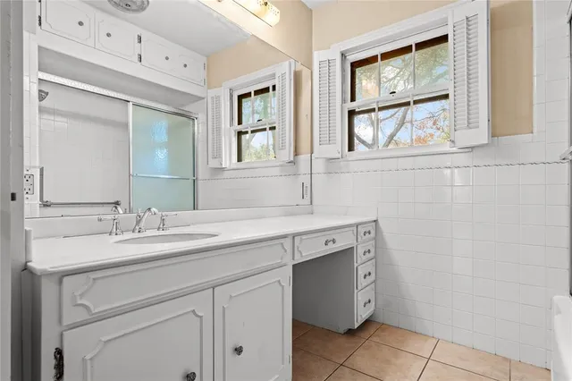 a spacious bathroom with a granite countertop sink mirror and double