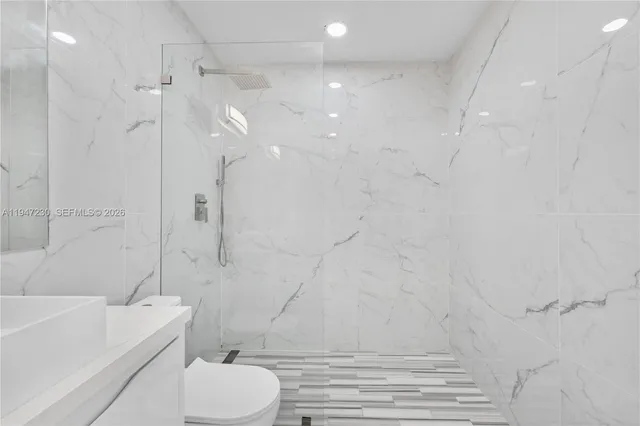 a bathroom with a toilet and a shower
