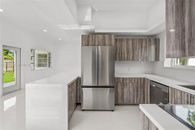 a kitchen with a refrigerator and a sink