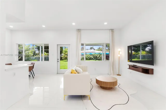 a living room with furniture and a flat screen tv