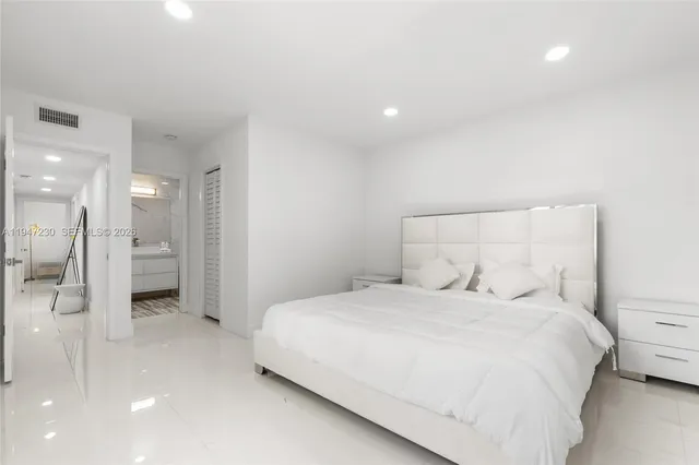 a bedroom with a bed and a walk in closet