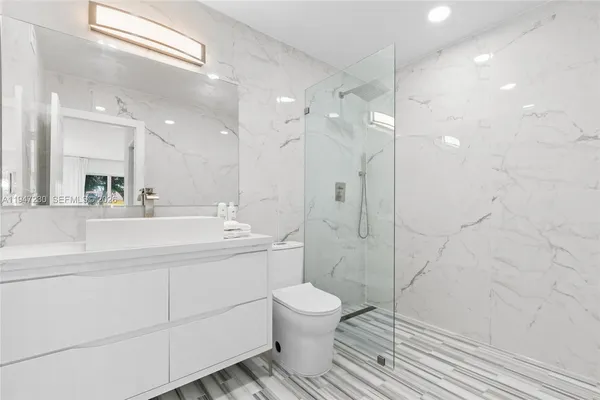 a bathroom with a toilet sink and shower