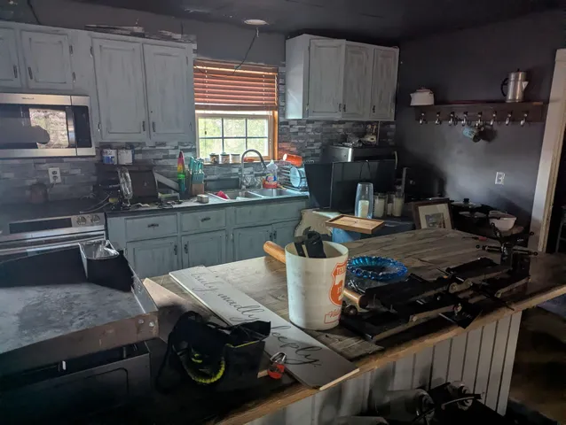 a kitchen with a table and chairs in it