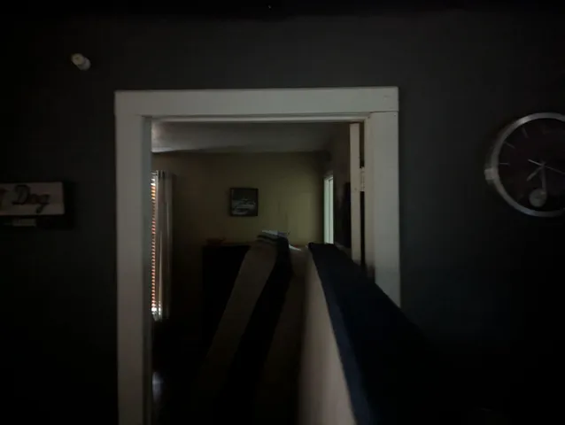 a view of a hallway with wooden floor and a fireplace