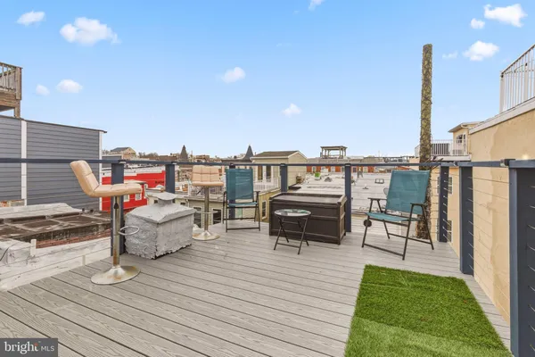 a roof deck with patio and barbeque oven