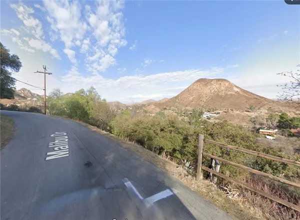 a view of a street with a mountain in the background