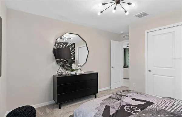 a bedroom with a bed and a ceiling fan