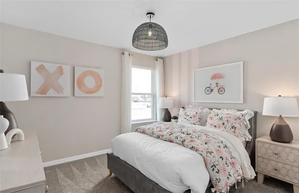 a bedroom with a bed and a mirror on dresser