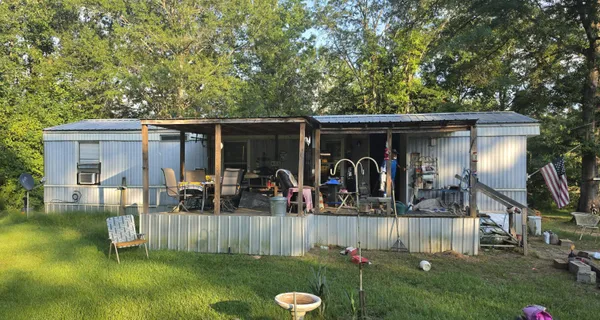 a view of a house with backyard porch and furniture