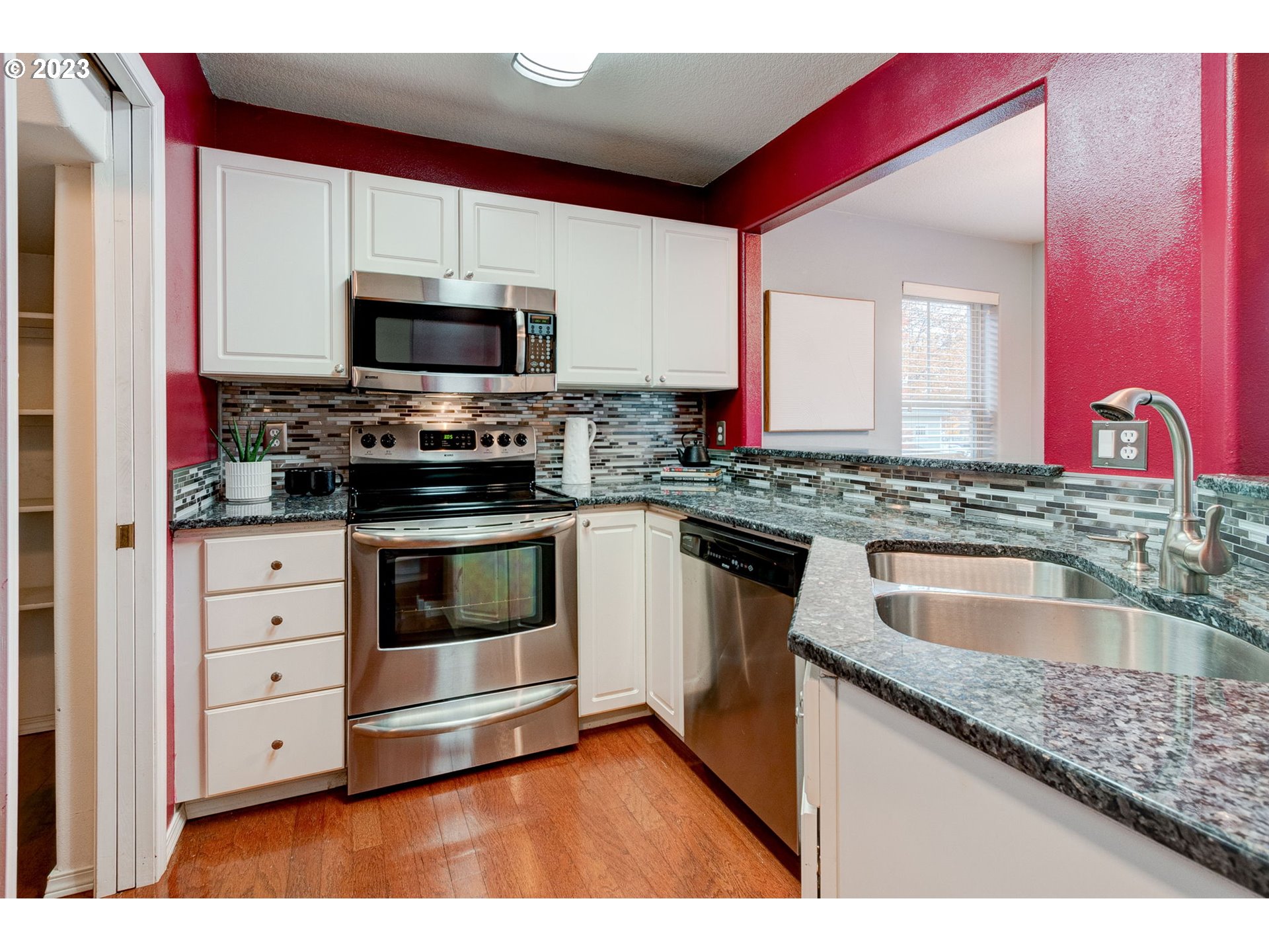 8255 Southwest Seneca Street Tualatin, OR 97062 - Photo 12 of 41 a kitchen with stainless steel appliances granite countertop a stove a sink and a microwave