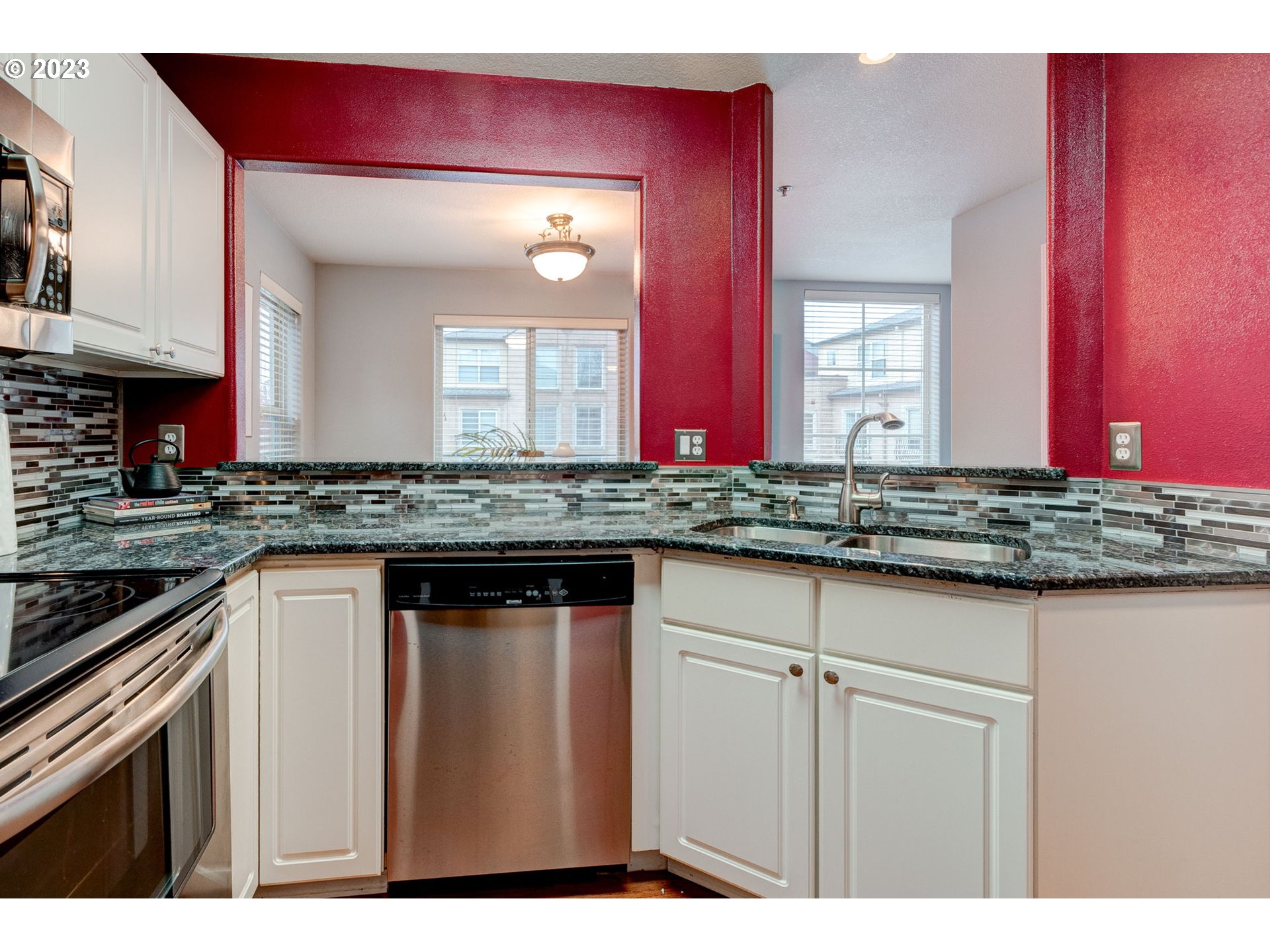 8255 Southwest Seneca Street Tualatin, OR 97062 - Photo 13 of 41 a kitchen with stainless steel appliances granite countertop a sink and cabinets