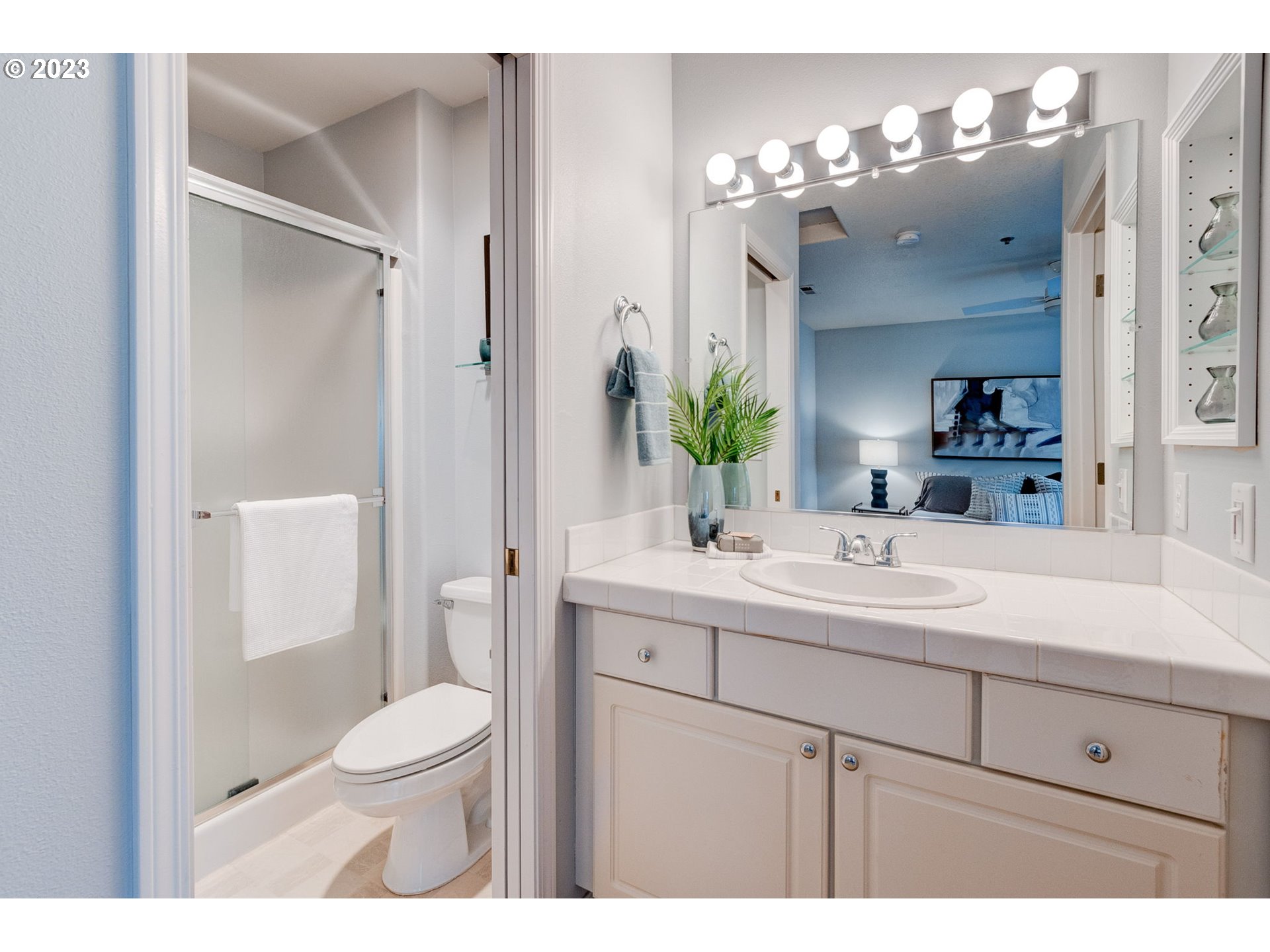 8255 Southwest Seneca Street Tualatin, OR 97062 - Photo 34 of 41 a bathroom with a sink a toilet a large mirror and shower
