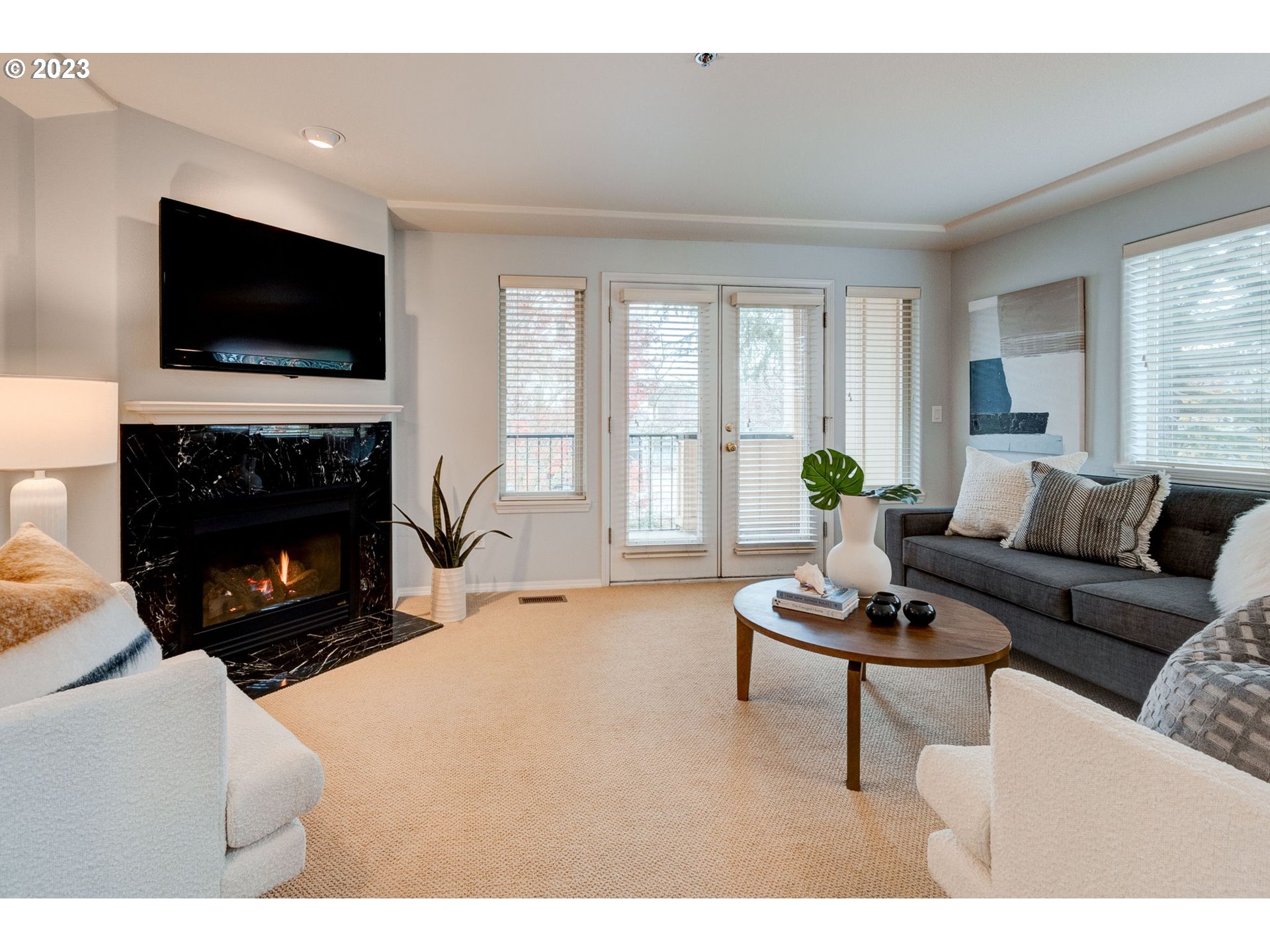 8255 Southwest Seneca Street Tualatin, OR 97062 - Photo 7 of 41 a living room with furniture a fireplace and a flat screen tv
