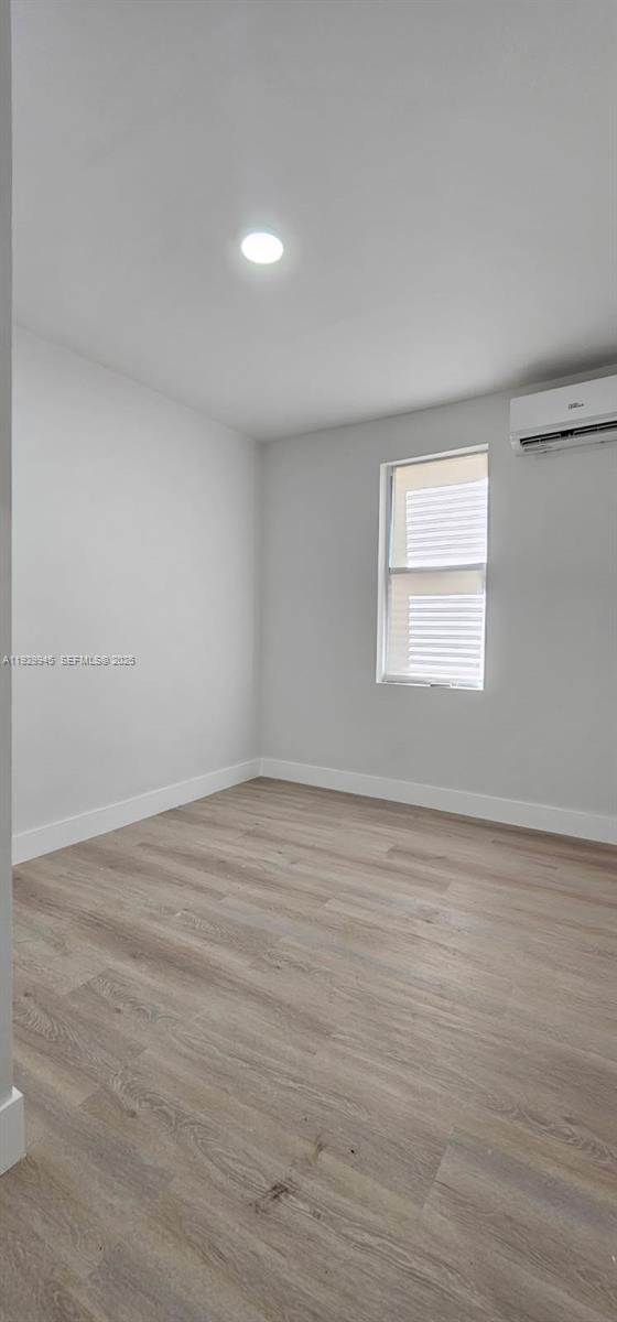 2425 Southwest 6th Street, Unit 4 Miami, FL 33135 - Photo 11 of 14 a view of an empty room with wooden floor and a window