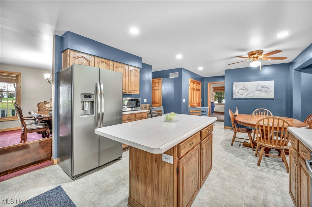 3181 Ridgewood Road Medina, OH 44256 - Photo 21 of 50 Kitchen featuring ceiling fan, appliances with stainless steel finishes, and a center island