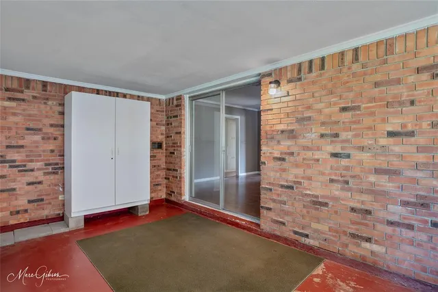 a view of empty room with window and wooden floor