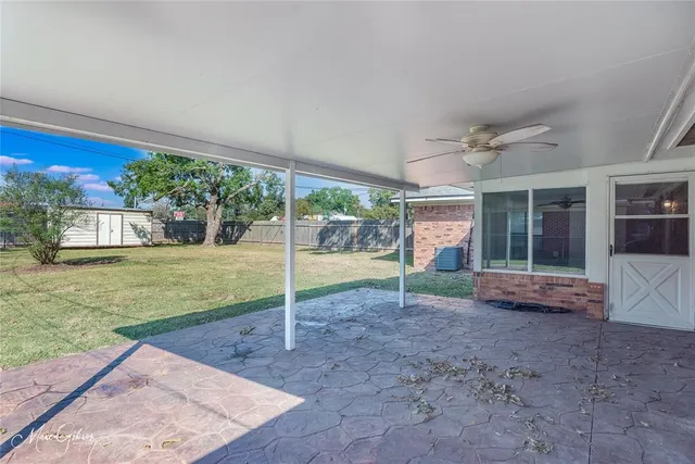 a view of a house with backyard and porch