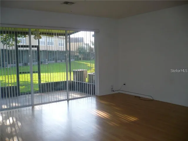 a view of empty room with floor to ceiling window