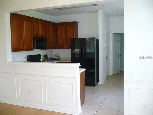 a kitchen with a refrigerator and cabinets