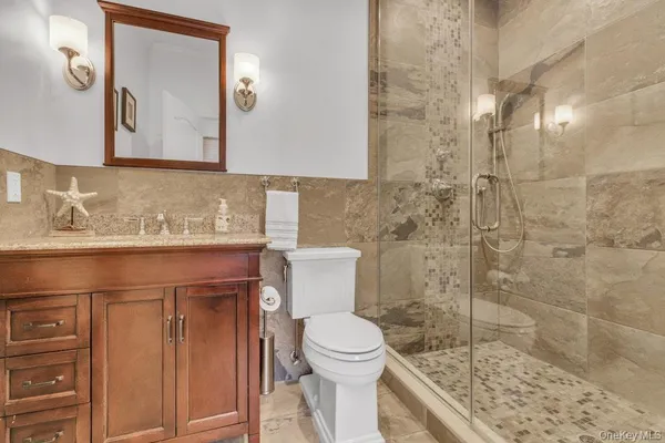 a bathroom with a sink toilet and shower