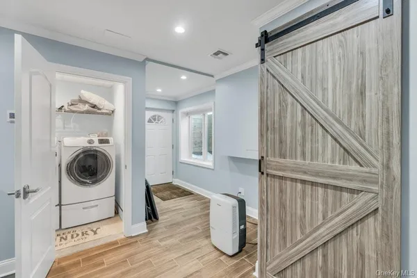 a view of a hallway with washer and dryer