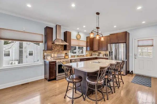 a large kitchen with a table and chairs