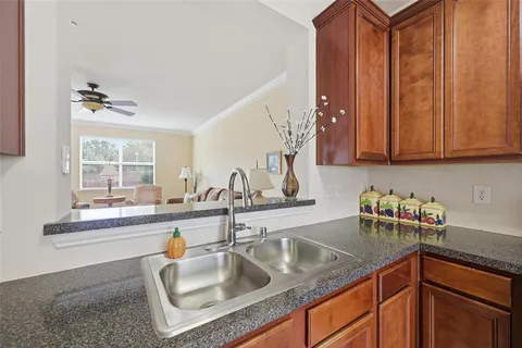 a kitchen with stainless steel appliances granite countertop a sink dishwasher and cabinets with wooden floor