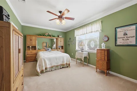 a bedroom with a bed and a mirror on the wall