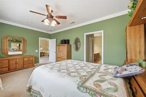 a bedroom with a bed and dresser with mirror