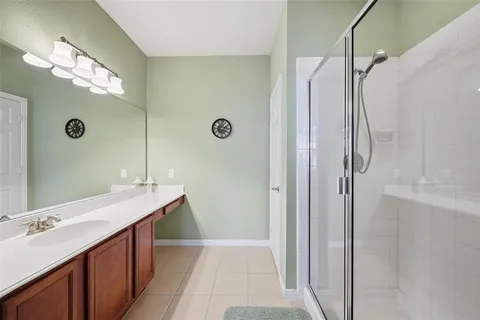 a bathroom with a double vanity sink mirror and shower