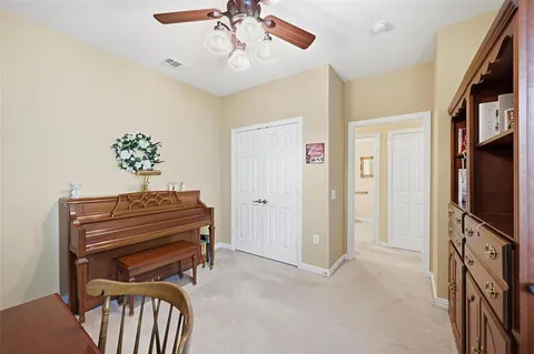 a view of room with a flat screen tv and a ceiling fan