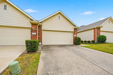 a view of backyard of house and garage