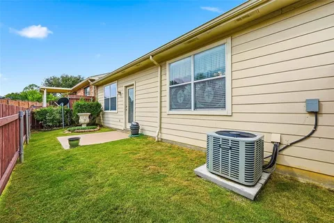 a view of a house with backyard and porch
