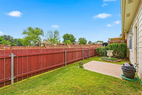 a view of a backyard with wooden fence