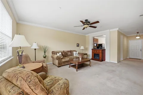 a living room with furniture and a chandelier