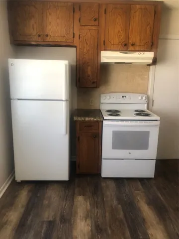 a kitchen with a stove top oven and cabinets