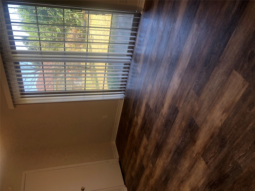 610 Cheyenne Drive Temple, TX 76504 - Photo 6 of 7 a view of an empty room with wooden floor and a window